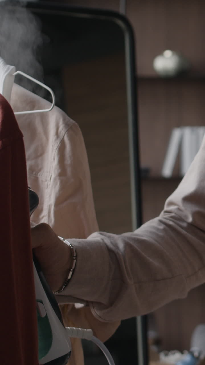 A man looking at his phone indoors