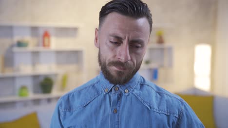 Portrait-of-unhappy-and-thoughtful-man-at-home.