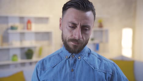portrait of unhappy and thoughtful man at home.