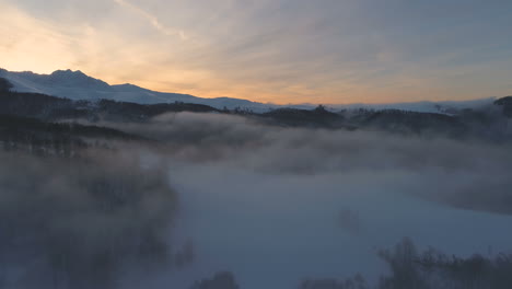 in clouds, mountain peaks and sunset colors