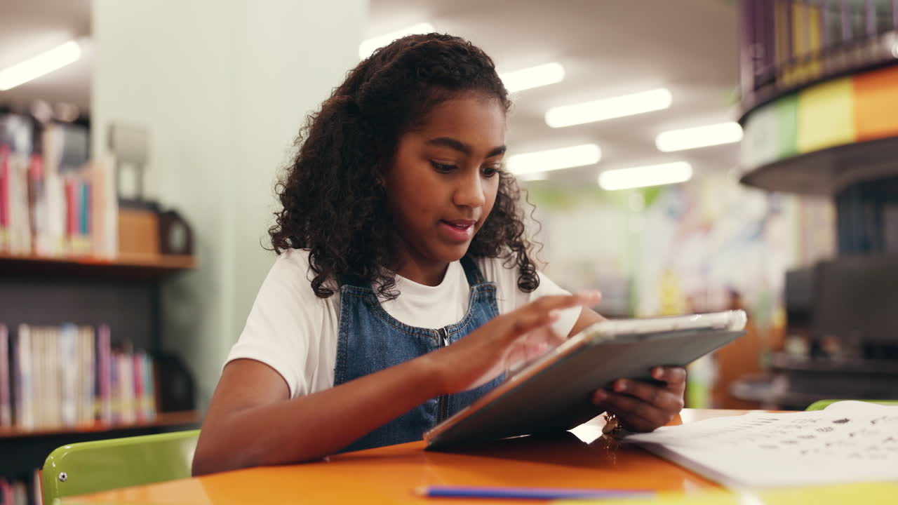 Girl using tablet in library
