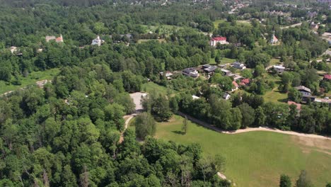 A-stunning-aerial-view-of-Sigulda-city,-highlighting-its-integration-with-lush-green-spaces-and-natural-landscapes