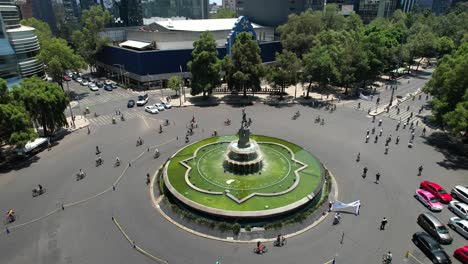 orbital drone shot of urban cycling in mexico city during a sunday