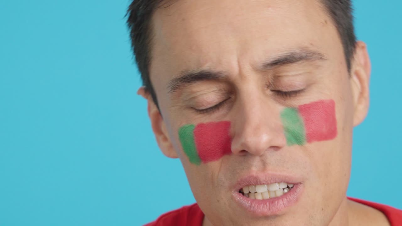 Very nervous man supporting portuguese team during a difficult match