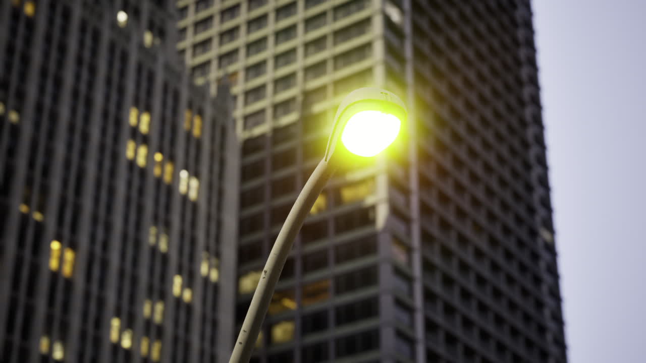 Streetlight illuminating urban landscape during twilight in metropolitan city