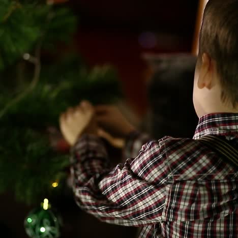 Mother With Son Decorating Christmas Tree