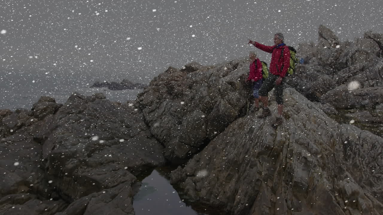 Hikers trekking snowy coastal rocks, overlaying animated map and temperature icons for marketing