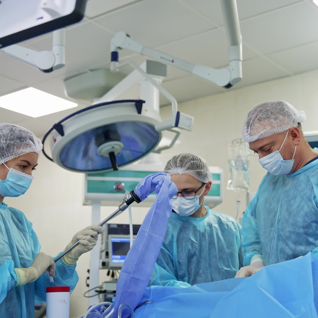 Medical team performing surgery on patient. Surgical team performing surgery in modern operation theater