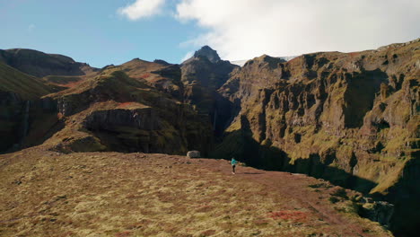 Tourist-walking-by-the-edge-of-the-Mulagjufur-Canyon-in-South-Iceland---aerial