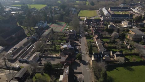 4k aerial view of a residencial area in taunton somerset, united kingdom, drone moving forward and showing the buildings roofs and street