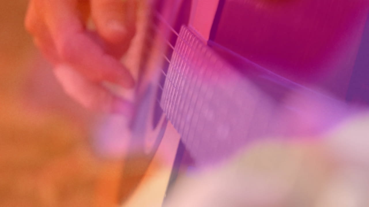 Guitarist fingers plucking strings in education tutorial, showing animated music notes floating