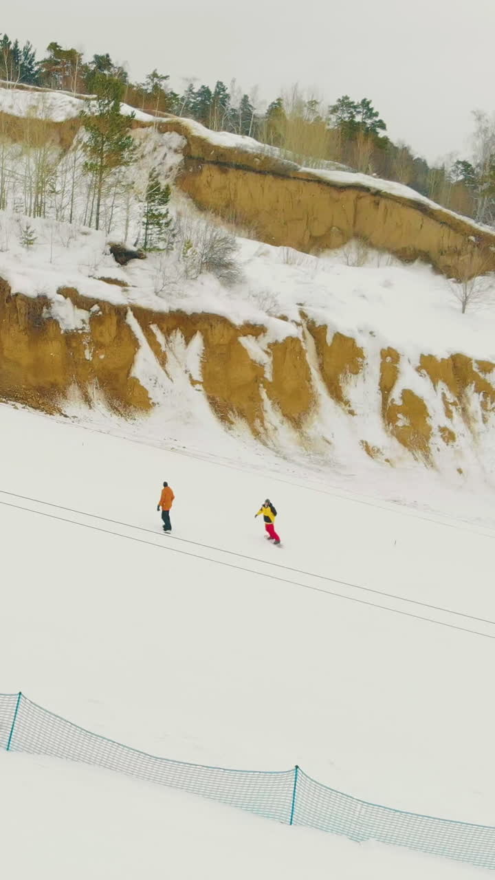 pictorial mountain slope for beginner skiers and t-bar surface lift at snowy hill on nasty day aerial view