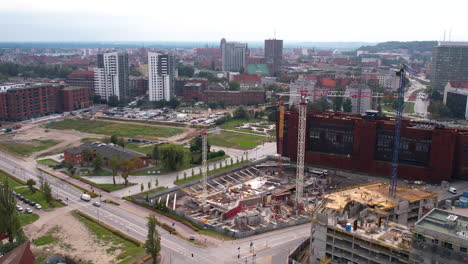 Aerial-view-of-an-urban-construction-site-with-cranes-and-buildings-in-Gdańsk