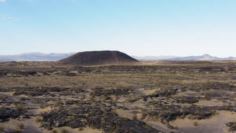 low altitude aerial view approaching volcanic amboy crater in the mojave desert