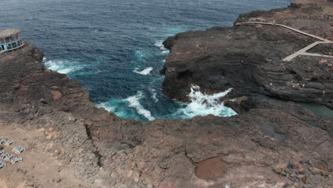 Atlantic-coast-on-Sal-Island,-Cape-Verde,-volcanic-stone-contrasting-with-the-Atlantic-Ocean