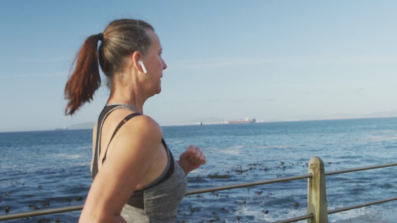 Donna anziana che corre su una passeggiata.