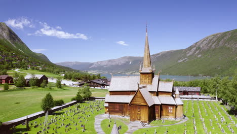 Front-Exterior-Of-Lom-Stave-Church-Overlooking-Mountain-And-Otta-River-at-Daytime-In-Norway