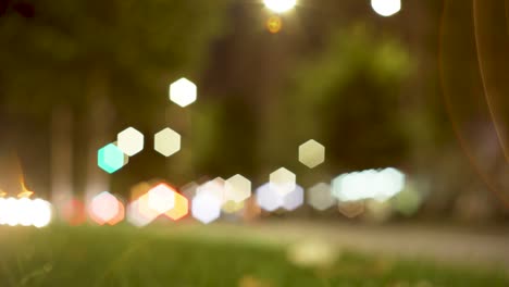 Rush-city-street-at-night-with-cars-passing-by-in-out-of-focus