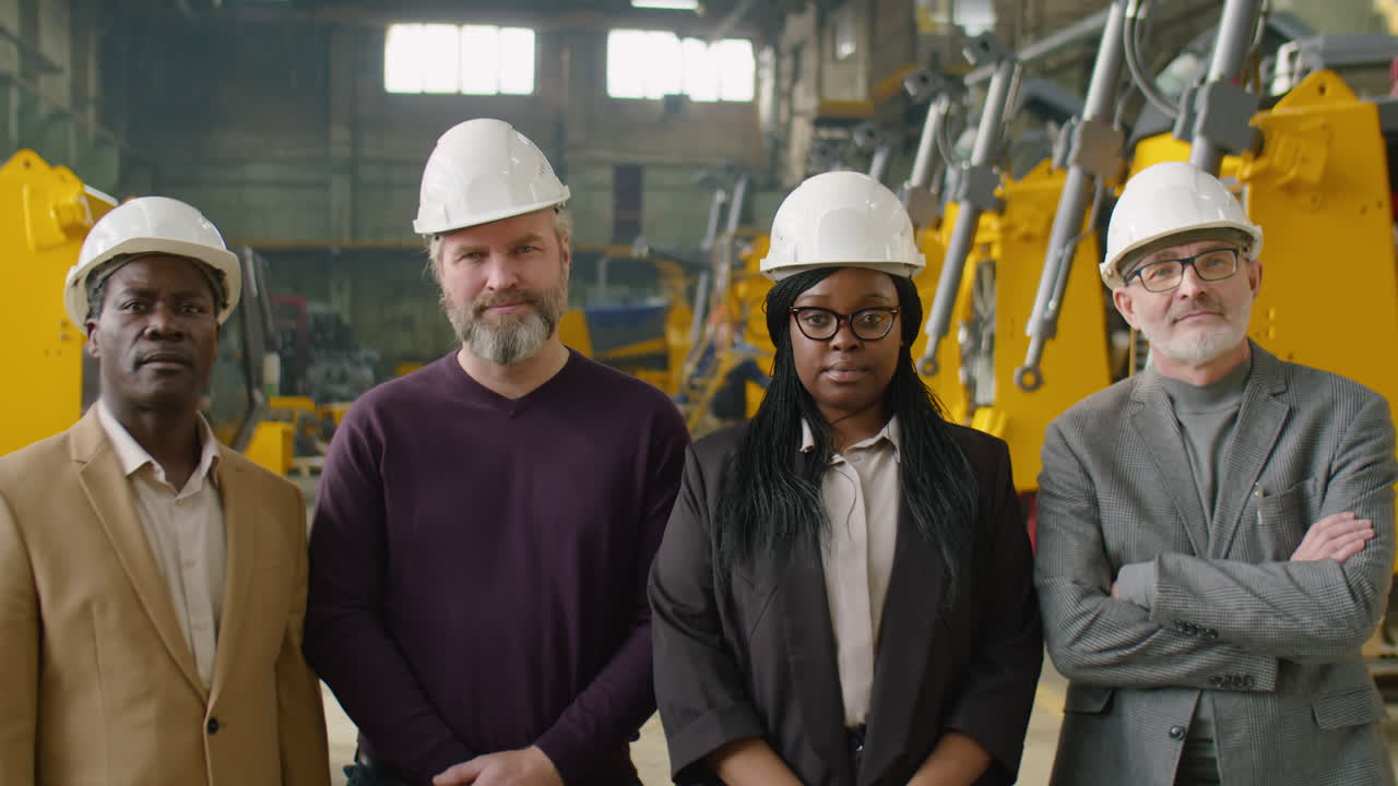 Group Portrait of Diverse Engineers at Heavy Equipment Factory