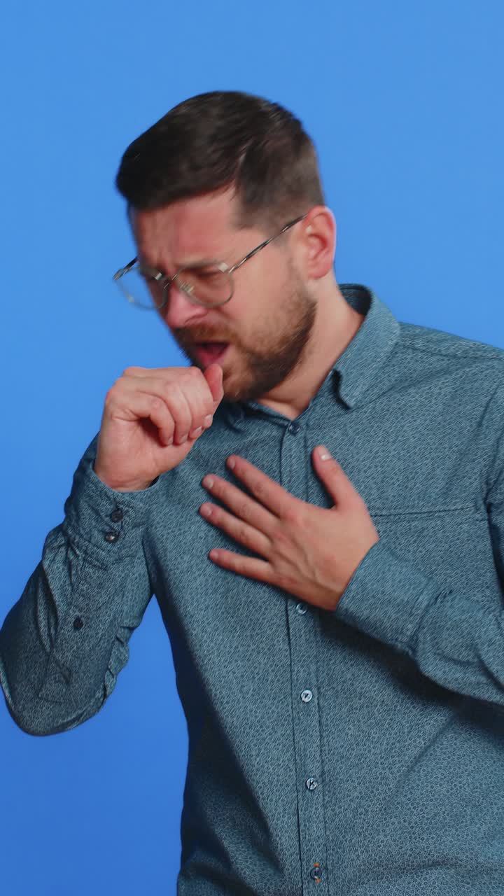 Unhealthy ill man coughing with seasonal flu symptoms sick allergy fever or viral infection