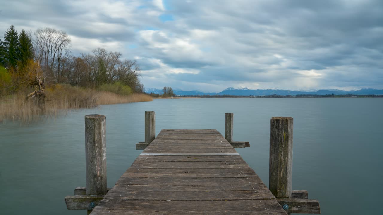 windy weather on a lake. The clouds move over the landscape. On the horizon you can see the mountain landscape