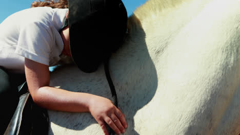 Girl-embracing-the-white-horse-in-the-ranch-on-a-sunny-day-4k