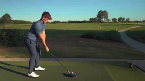 golfer taking a swing on a driving range