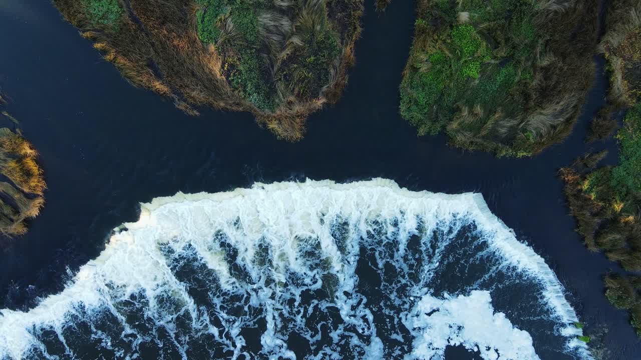 Top-down drone view of waterfall Venta Rapid, Europe widest waterfall, Kuldīga