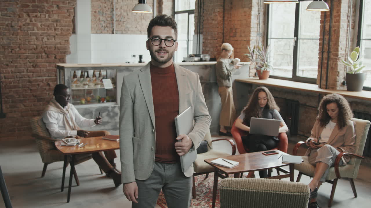 Bearded Man with Laptop Smiling to Camera