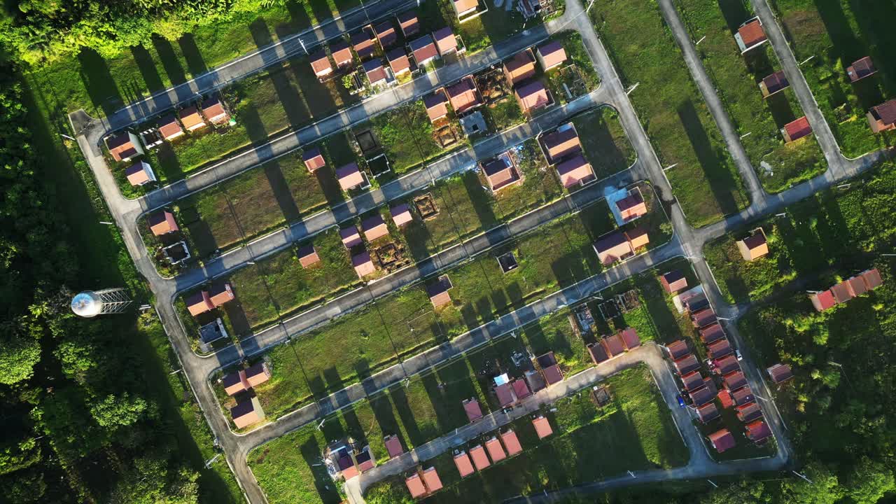 Top view drone shot highlighting the structured layout of a tropical residential community with aligned homes and green surroundings at Residential Subdivision in Cavite Philippines
