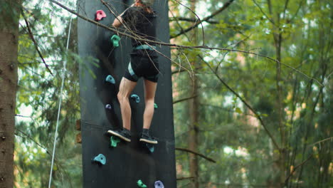 boy going down in a climbing wall