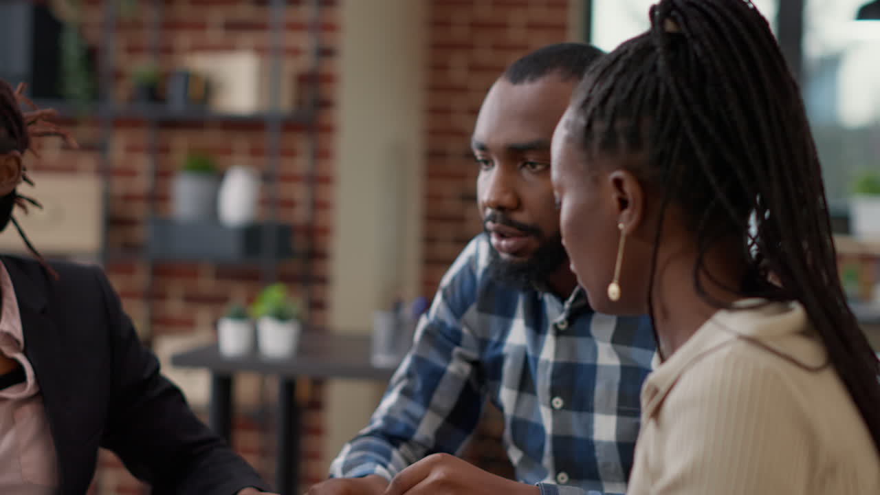 African american startup team working with statistics papers on project