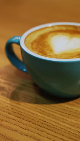 teal cup of latte art