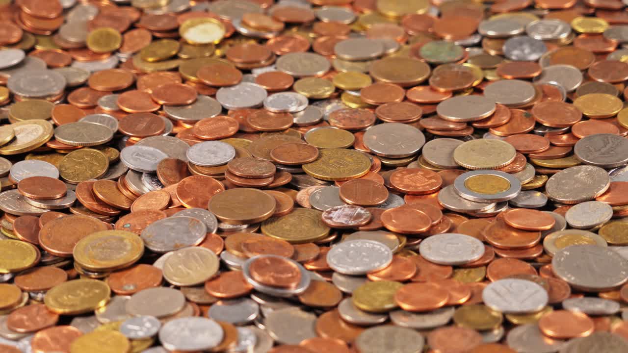 Coins scattered on a flat surface in a random arrangement