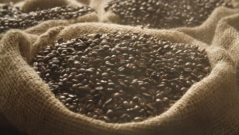 fresh roasted coffee beans falling into linen sack in slow motion