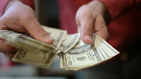 close up of busness man hands counting money cash. finance business success