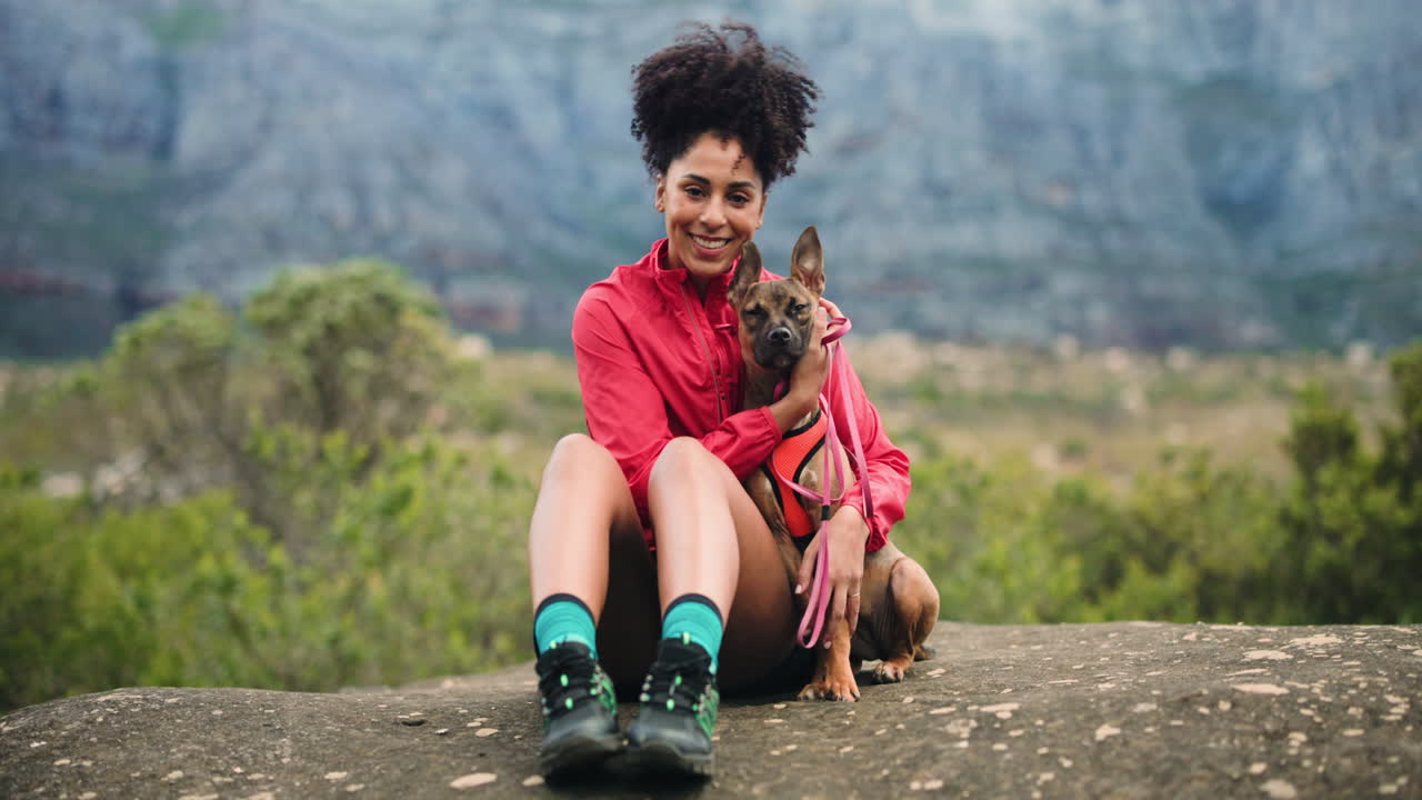 Woman hiking with her dog in the mountains