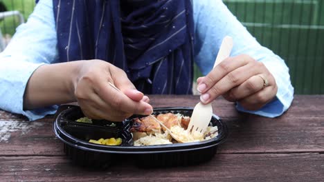 Curry-chicken-and-rice-in-a-take-away-plastic-packet-on-table