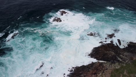 Breaking-Waves-Onto-Rugged-Shore-With-Foamy-Surface-In-Caion-Beach,-Coruna-Spain