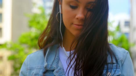 young woman using mobile phone in the city 4k