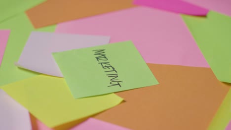 business concept of revolving sticky notes with marketing written on top note 1