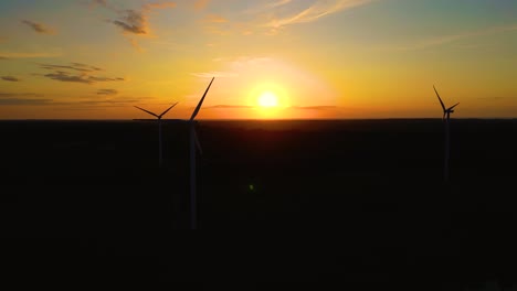 silhouettes windmills large orange sun disc summer lens flare