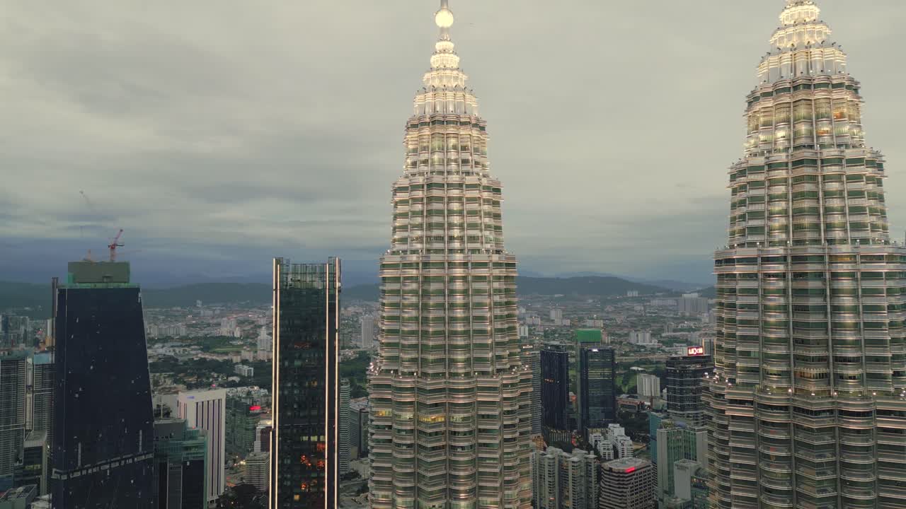 Aerial Fly Kuala Lumpur Malaysia at dusk twin skyscraper towers business area, downtown of southeast Asian capital