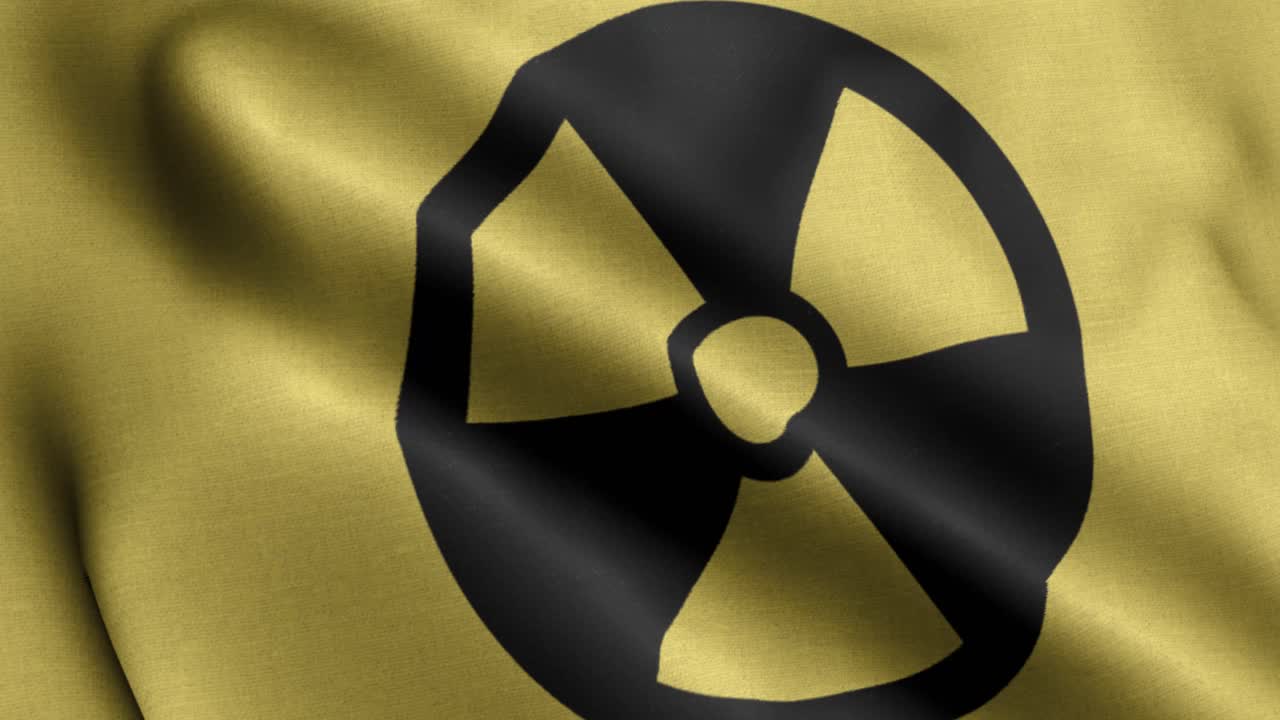 primer plano 4k bandera ondeante del logotipo nuclear en fondo amarillo