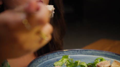 woman enjoying the taste of fresh tuna dish at the restaurant for dinner