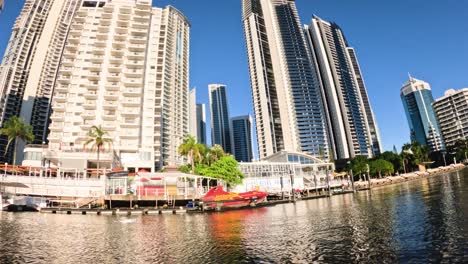 time-lapse of boats and buildings along a river