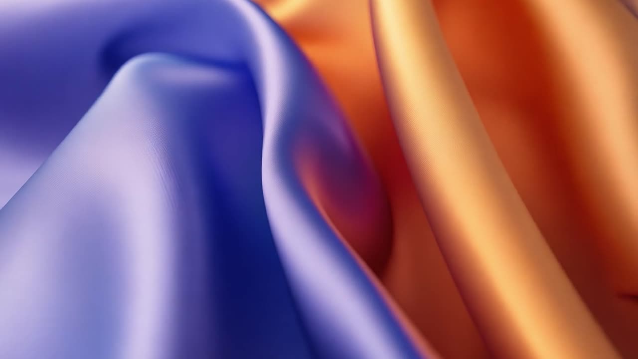 primo piano di tessuti di seta drappeggiati in blu e arancione