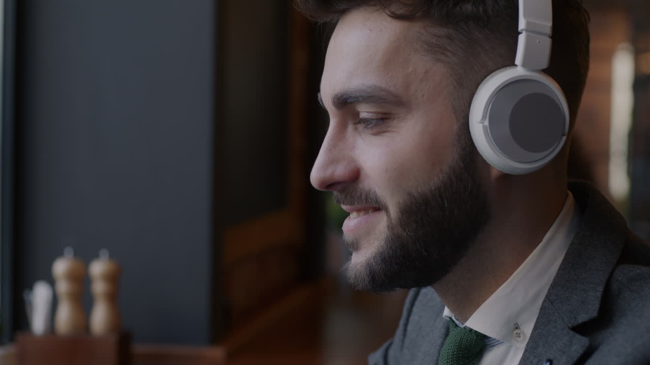 Businessman enjoying coffee and music in a cafe
