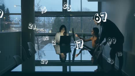 animation of numbers moving over people working late in office using computers