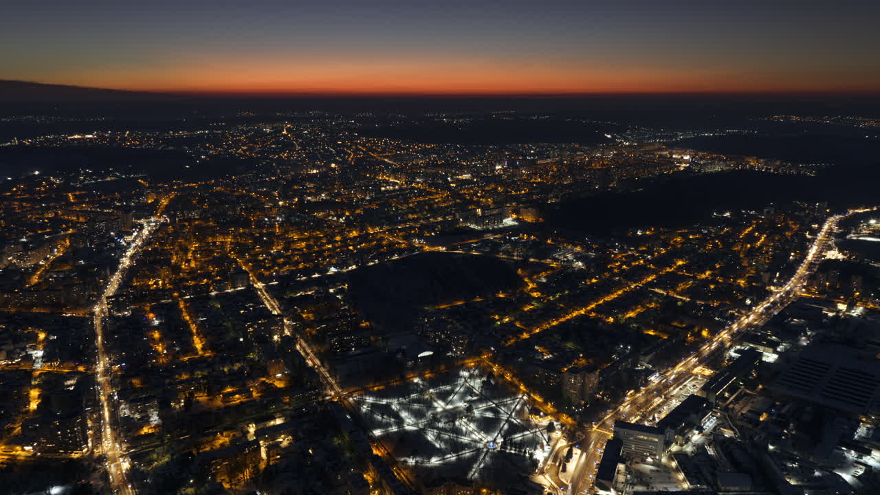 Aerial drone hyperlapse timelapse of Chisinau city covered in snow at night. Winter in Moldova